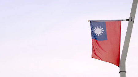 Taiwan flag waving gracefully against a clear sky with empty copy space for text, representing freedom and national pride.の写真素材