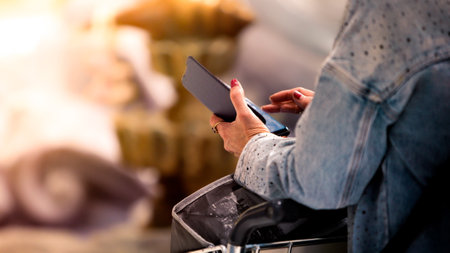 Closeup shot of hands holding a smartphone in international modern airport. Focus on modern connectivity and travel. Ideal for technology or lifestyle themes.の写真素材