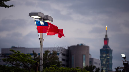 National flag of Taiwan waving with iconic Taipei 101 in background, showcasing national pride.の写真素材