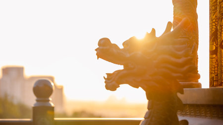 Closeup of traditional dragon statue at Sanyang Longjing Tiangong temple in Taichung, Taiwan, with warm sunlight illuminating the sceneの写真素材