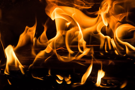 Yellow fire burning woodの写真素材