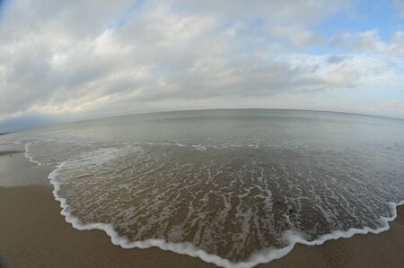 sea beach sunset shot made by fisheye lensの写真素材