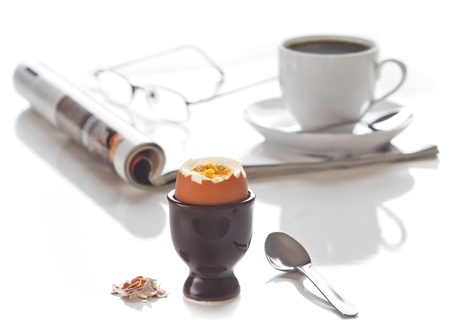 Breakfast. Egg with coffee. Focus on the egg. Isolated on white.の写真素材