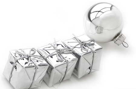 Present boxes and silver bulb on white.の写真素材