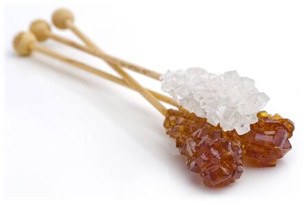 Candy brown and white sugar on a sticks. With white background.の写真素材