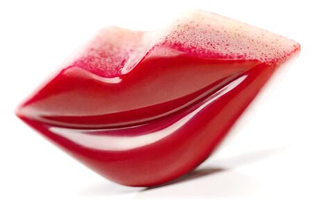 Lips shaped Praline coated with burgundy glaze  White background の写真素材
