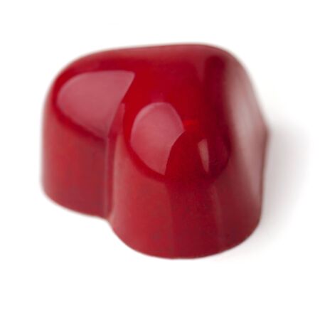 Heart shaped Chocolate Praline coated with burgundy glaze  White background  Soft focus の写真素材