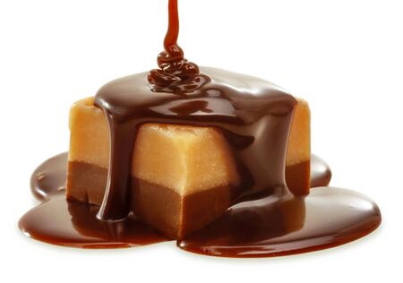 Chocolate flow on Fudge. Isolated on a white.の写真素材