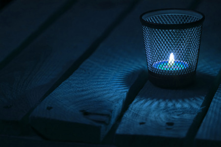 Candle light on natural wooden background. Tealight.  Soft focus.の写真素材