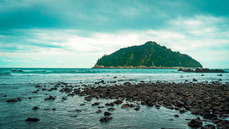 Beautiful seascape with a rocky island in the background.の写真素材