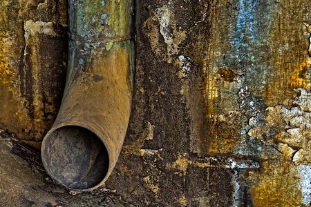 Rusty, old, pipe under a rail road  bridgeの写真素材