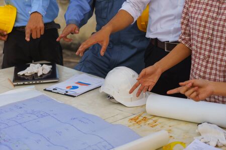 Engineer and blue collar workers are having meeting.の写真素材