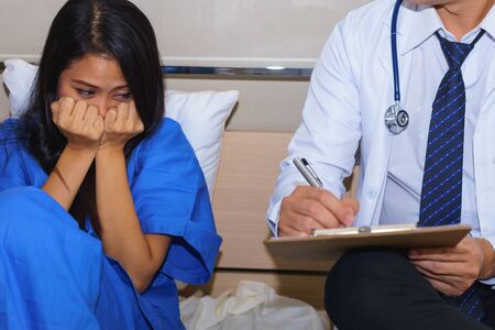Mental disorder female patient is facing psychiatrist.の写真素材