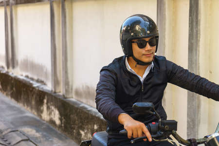 Handsome motorcyclist and his motorcycle.の写真素材