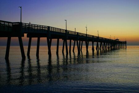 Pier over calm water at sunrise 2の写真素材