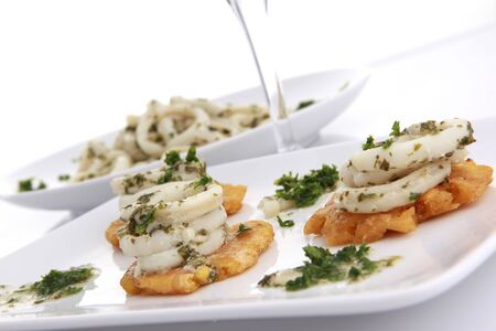 Garlic calamari on toasted plantainの写真素材