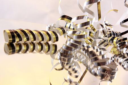 Curly serpentines cascading on a mirror on whiteの写真素材