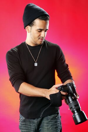 Young photographer on red background