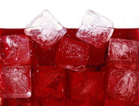 Ice cubes in red drinkの写真素材
