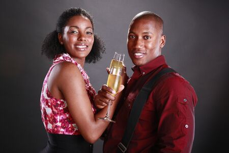 An african american couple cheers with champagne flutesの写真素材