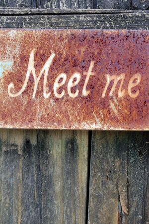 Weathered sign on a crumbling fenceの写真素材