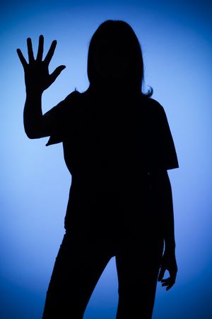 isolated on blue silhouette of woman showing stop