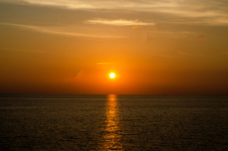 Beautiful sunset over the sea. The sun sets over the sea, Kalim Bay, Phuket, Thailandの写真素材