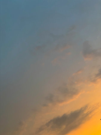 Clouds in the blue sky at sunset as an abstract background.の写真素材