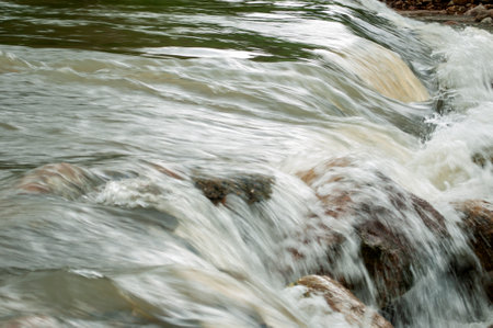 Water flowing over rocks in the river in Nakhon Si Thammarat, Thailand, closeup of photoの写真素材