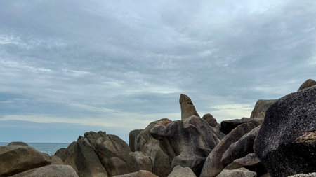 Hin Ta Hin Yai rocks on the beach with cloudy sky and sea in the background in Koh Samui, Thailandの写真素材