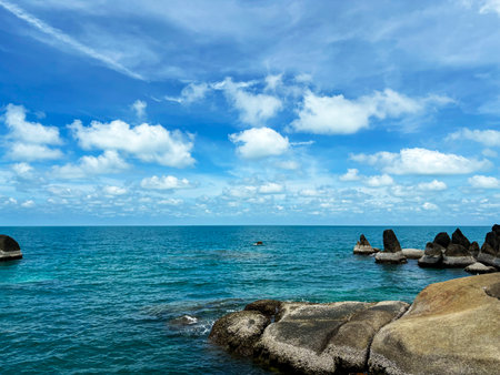 Tropical beach with granite boulders and blue sky with clouds, Hin Ta Hin Yai Rock Formations in Koh Samui, Thailandの写真素材