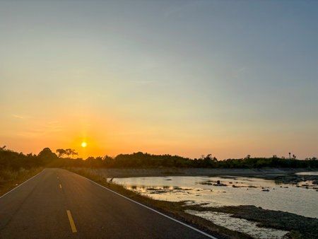 Sunset on the road in the countryside of Talay Prong Lake in Nakhon Si Thammarat, Thailandの写真素材