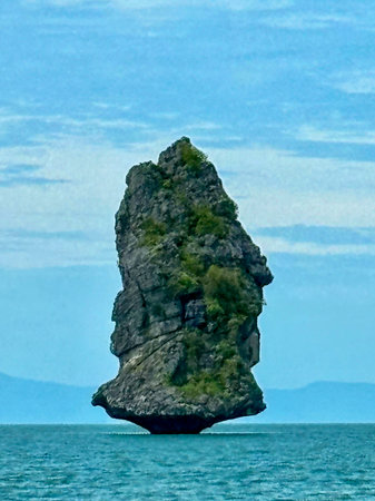 A large rock formation in the middle of the oceanの写真素材