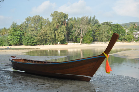 Traditional wooden boat on the beach in Thailand, South East Asia.の写真素材