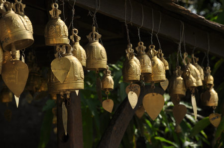 Buddhist bells hanging on the roof of a temple in Thailand