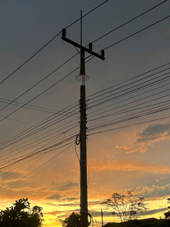 Electricity post with beautiful sunset sky in the countryside of Thailand.の写真素材