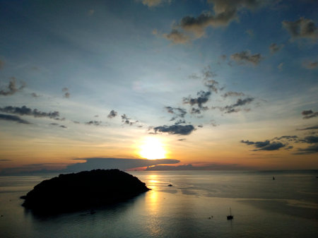 Sunset over the sea, the view from Windmill Viewpoint in Phuket, Thailandの写真素材