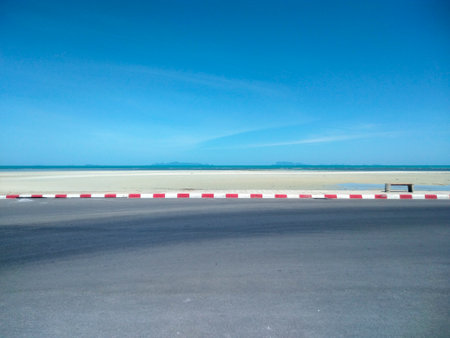 Empty asphalt road through the sea with blue sky background, Nathon Beach, Koh Samui, Thailandの写真素材