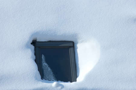 reflecting window surrounded with white untouched snow