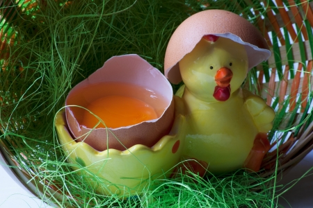 fresh egg in a basket with yellow duckの写真素材