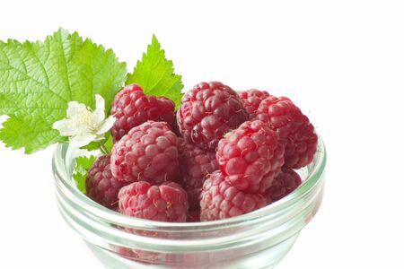 raspberry with green leaf isolated on white background
