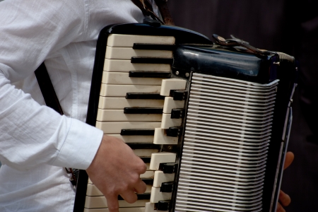 male hands manipulating the accordionの写真素材