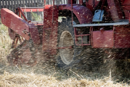  harvesting combine cutting  different grain in the field during the  fallの写真素材