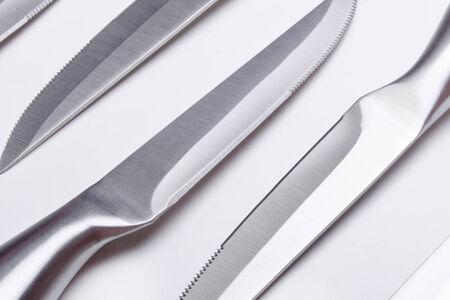 sharp kitchen instruments represented by metallic knivesの写真素材