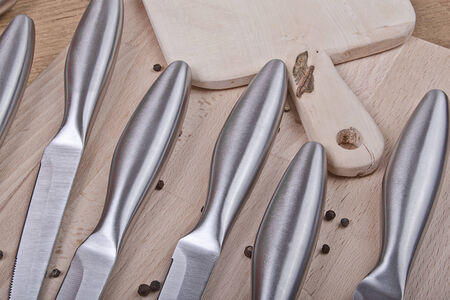 sharp kitchen instruments represented by metallic knivesの写真素材