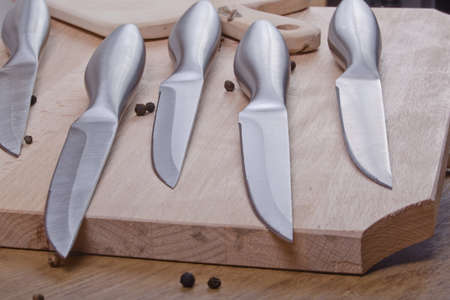 sharp kitchen instruments represented by metallic knives