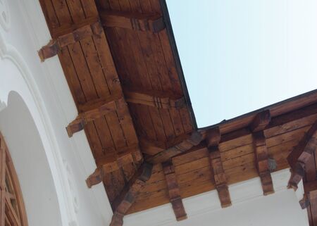 roof details revealing resistance wood beam and white wall