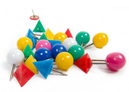 various colored cork board pins isolated on white background
