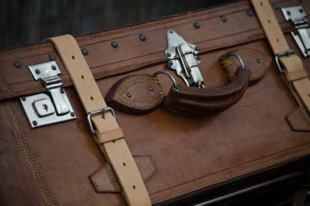 brown vintage suitcase made of leather and metallic closuresの写真素材