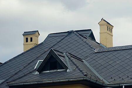 modern black tin roof with two chimneyの写真素材